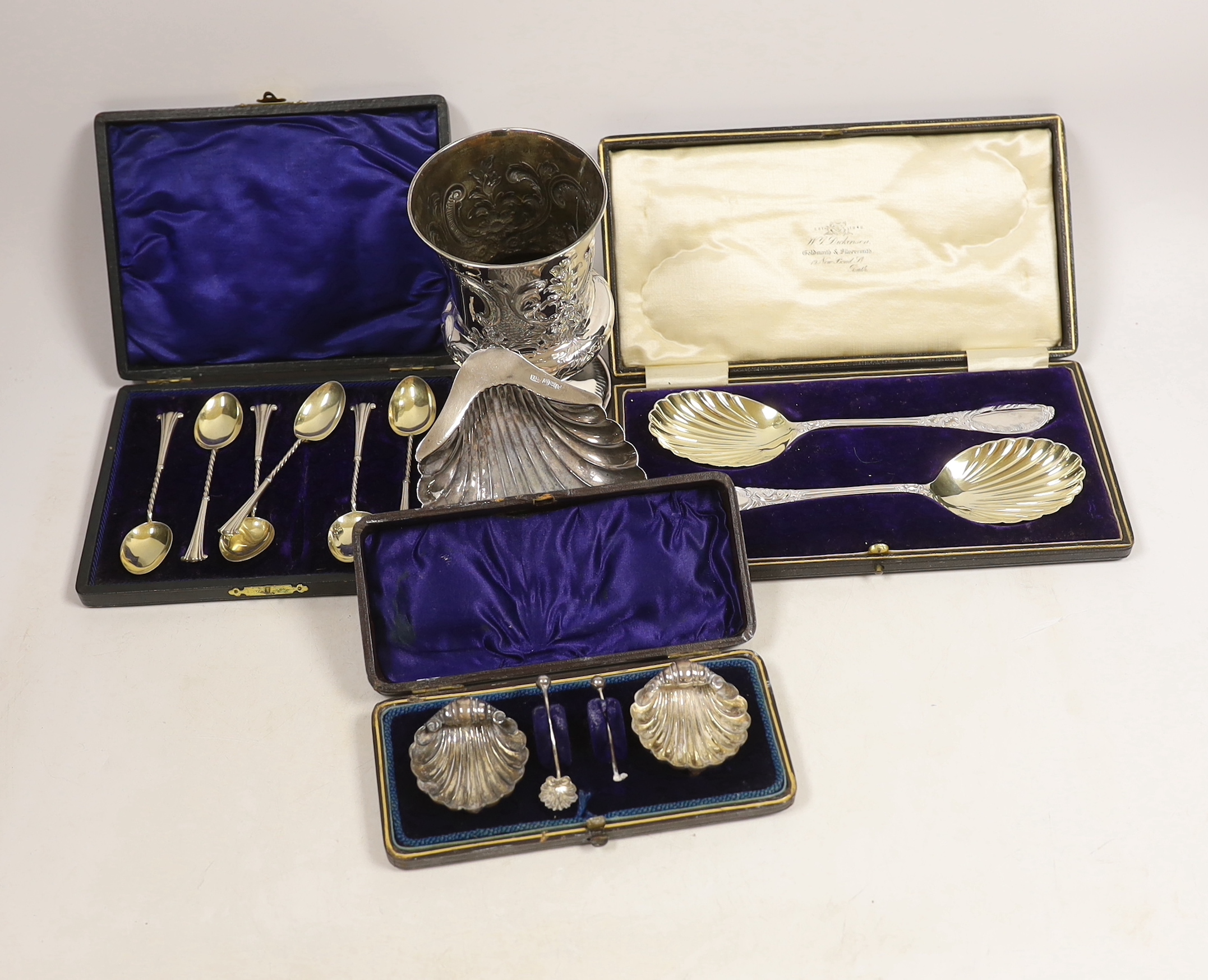 Three assorted cased sets of silver including a pair of spoons, Sheffield, 1908, teaspoons and pair of salts, together with a silver butter shell and earlier damaged goblet.